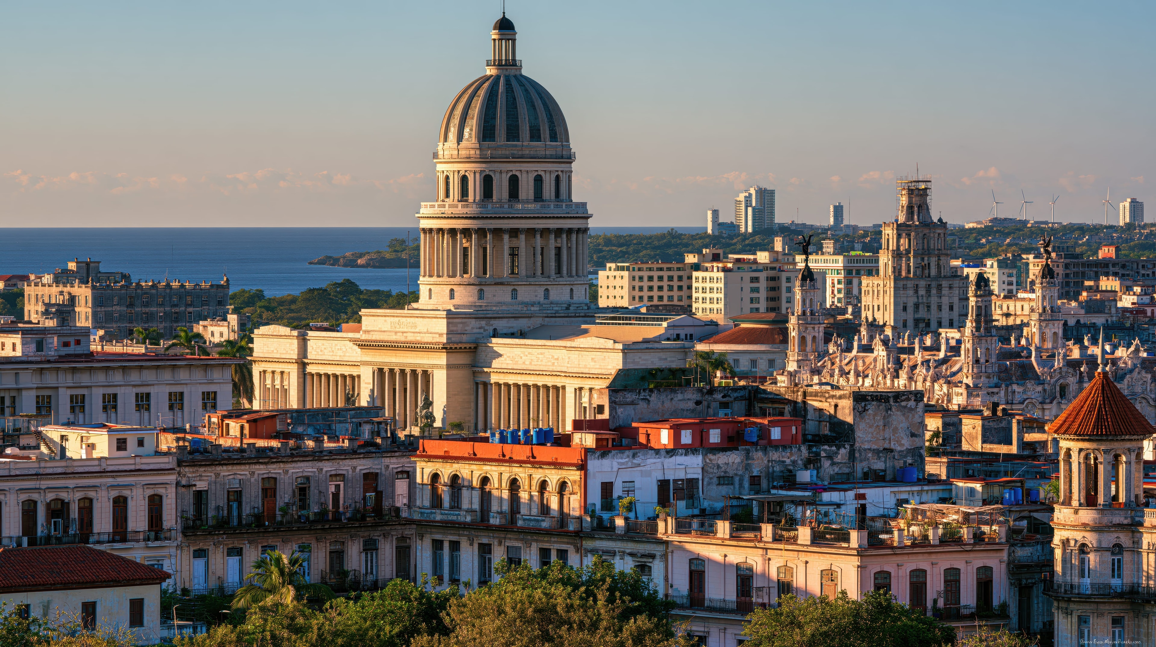 El Capitolio Havana dome rising above colonial rooftops and Gran Teatro tower at golden hour, Cuba