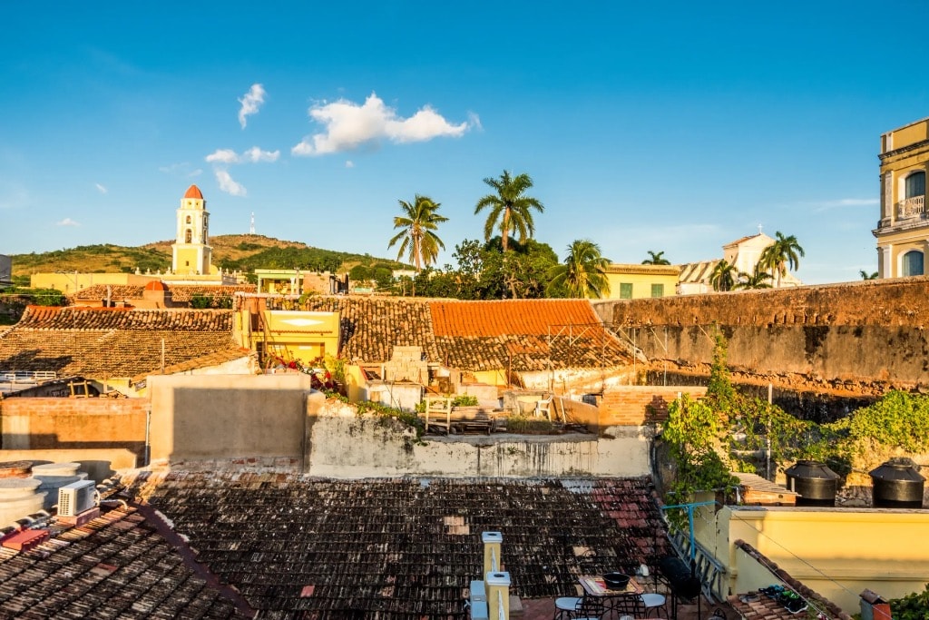 Trinidad Cuba rooftop view with bell tower and terracotta roofs at golden hour