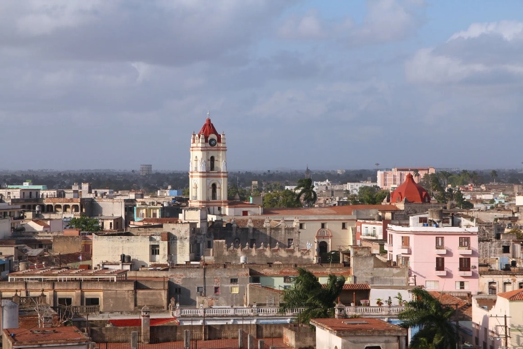 Camagüey Cuba rooftop panorama with colonial church bell tower and red domes