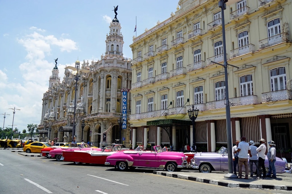 Gran Teatro de La Habana with colorful vintage convertibles lined up outside Hotel Inglaterra
