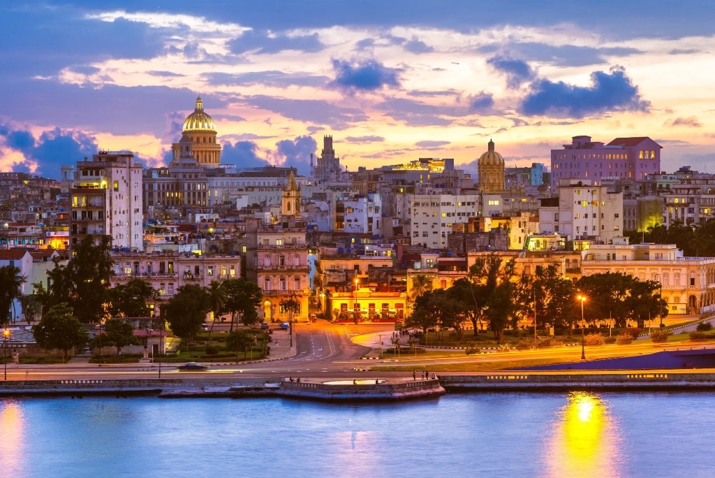 Havana skyline at sunset with Capitol dome reflecting in harbor waters