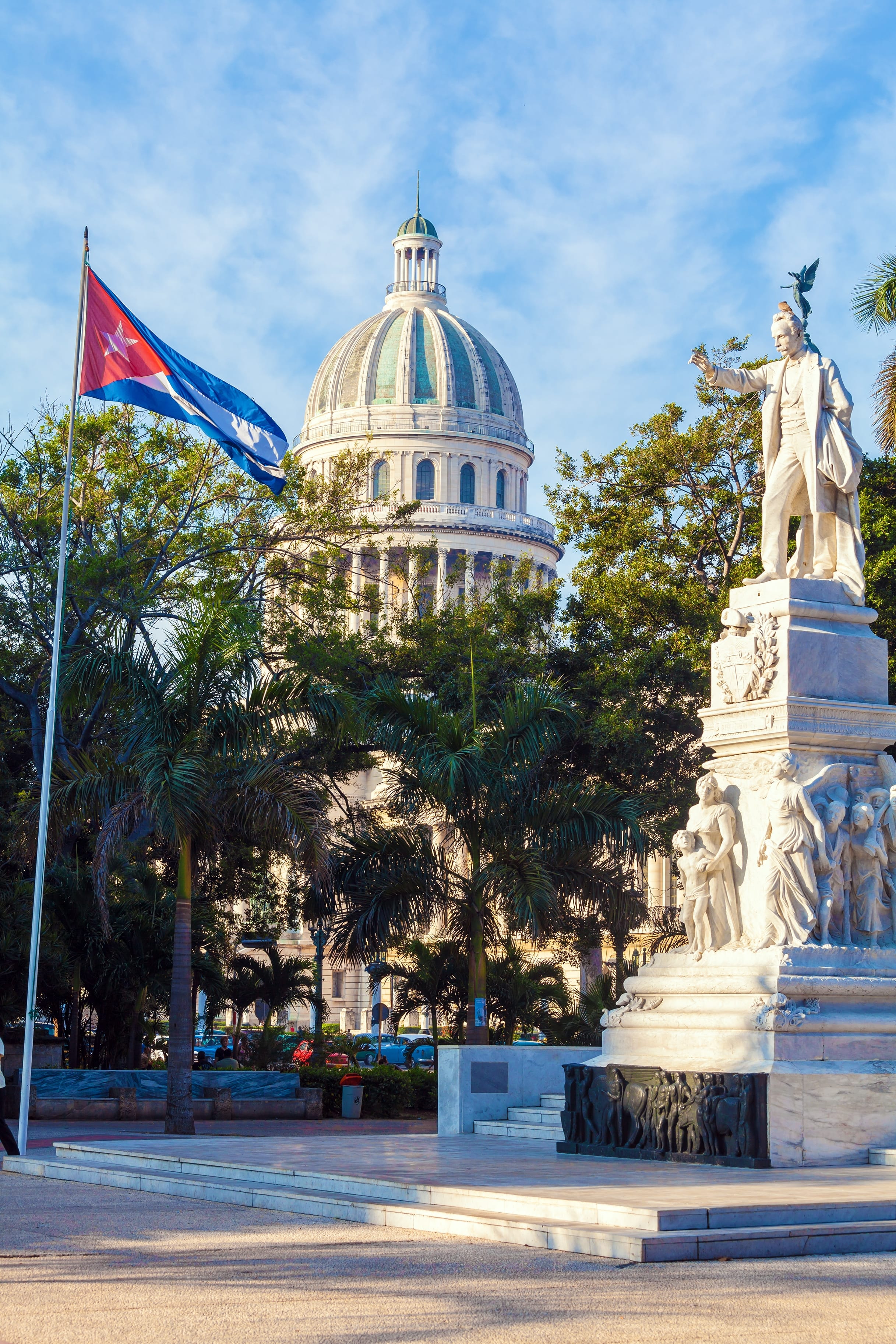 José Martí statue with Cuban flag and El Capitolio dome in background Havana Cuba